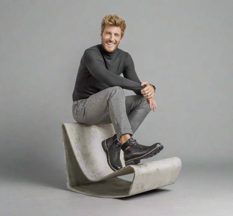 man wearing Ferracini shoes sitting on a chair